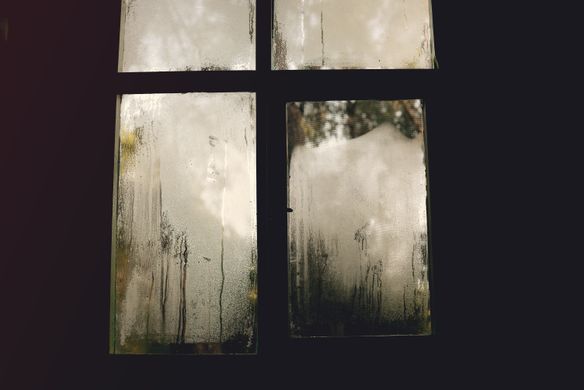 Foggy window with condensation showing the visible effects of high indoor humidity